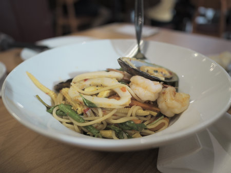 Delicious seafood pasta dish restaurant food photography cozy dining environment close-up view culinary delightの写真素材