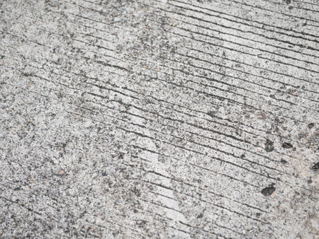 Detailed close-up of textured concrete surface urban environment abstract photography industrial setting minimalist perspective design aestheticの写真素材