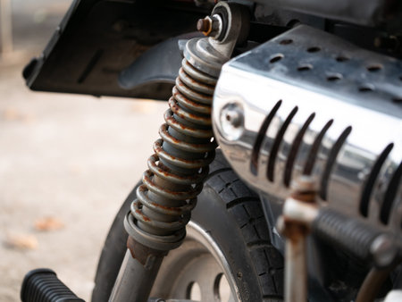Motorcycle suspension system close-up urban setting technical photography industrial environment...