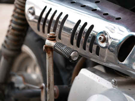 Motorcycle engine part close-up garage workshop mechanical component industrial environment macro viewpoint technical detailの写真素材