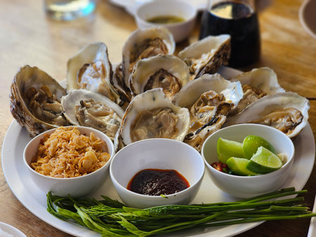Oysters on a plate seafood restaurant culinary art indoor dining close-up freshness and flavorの写真素材