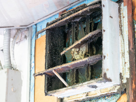 Neglected air vent cleaning abandoned building photo documentation urban decay close-up view health hazard awarenessの写真素材