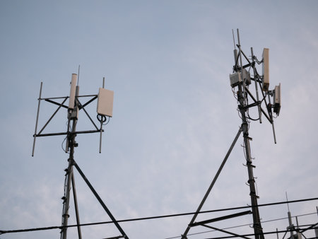 Telecommunication towers in urban sky technology infrastructure industrial setting evening light...