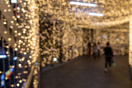 Festive lights celebration urban walkway photography nighttime blurred view holiday spiritの写真素材