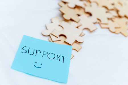 Business support puzzle pieces office desk digital note organized environment close-up view teamwork...