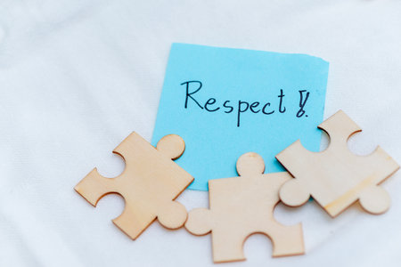Puzzle pieces of respect business collaboration in personal growth office space inspirational message calm environment close-up viewpointの写真素材