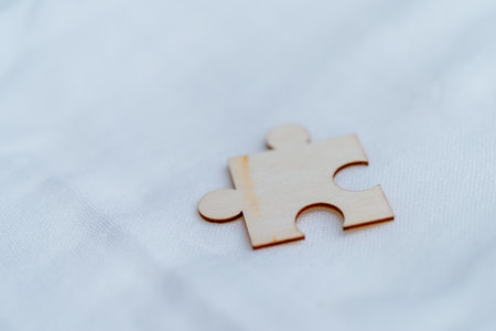 Solving business challenges a single puzzle piece on white background abstract concept minimalistic setting close-up viewの写真素材