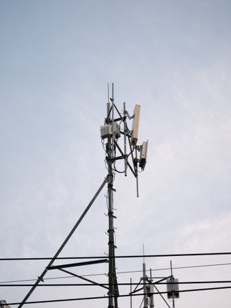 Telecommunication tower installation urban area infrastructure development clear sky elevated view...