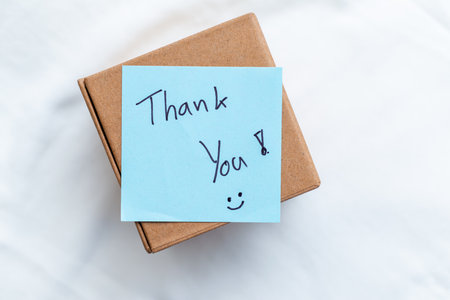 Thank you note on package home delivery business communication cozy environment personal touch gratitude conceptの写真素材