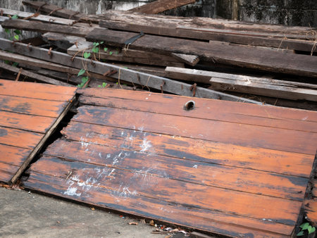 Discarded wooden planks construction site raw material urban setting ground level sustainability...