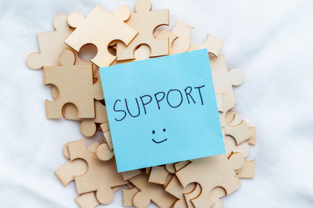 Supporting business growth puzzle pieces of teamwork office space image of collaboration positive...