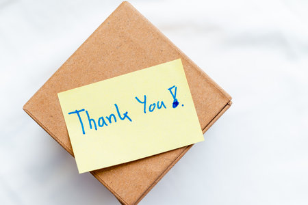 Gratitude in business unboxing a thoughtful package home office gift content minimalist environment close-up view appreciation conceptの写真素材