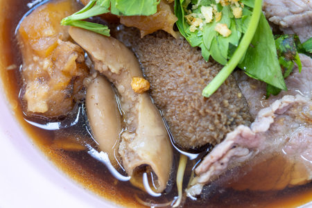 Delicious bowl of traditional asian beef noodle soup local eatery culinary dish cozy restaurant close-up authentic flavors for food loversの写真素材