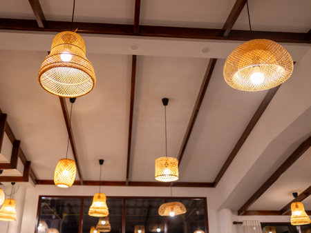 Charming pendant lights illuminate cozy interior creating inviting atmosphere for patronsの写真素材