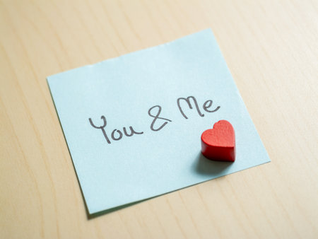 Romantic note with heart desk interior close-up love conceptの写真素材