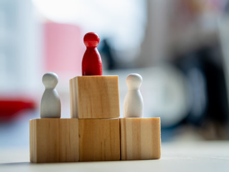 Leadership dynamics in business wooden figurines on blocks office setting conceptual visualizationの写真素材