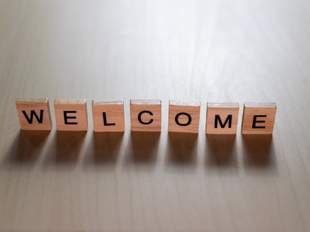 The image depicts a welcoming message crafted from wooden blocks perfect for inviting guests.の写真素材