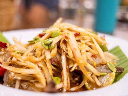 Delicious thai green papaya salad local market food urban setting close-up culinary experienceの写真素材