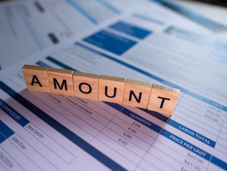 A close-up of invoice sheets highlighting the wordAmountillustrating financial details.