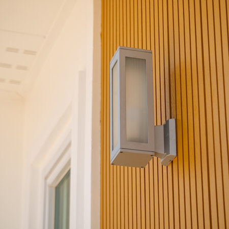 Explore the sleek design of a modern outdoor light fixture enhancing a contemporary home's exterior.