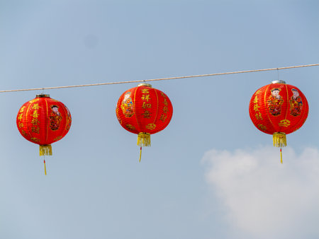 Bright red lanterns symbolize joy and celebration during cultural festivities in an urban outdoor setting.の写真素材