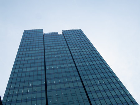 A striking modern skyscraper showcasing sleek glass architecture against a clear sky.