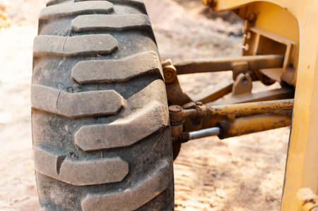 A close-up view of a heavy machinery wheel highlighting the details of equipment maintenance at a construction site.の写真素材