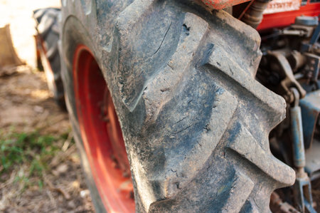 A detailed close-up of a tractor tire showcasing its rugged texture and connection to farming...