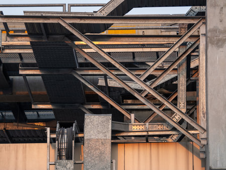 Explore the intricate steel framework of an industrial construction site at dusk.