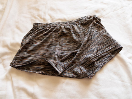 A close-up image showcasing casual boxer shorts laid out a bed highlighting comfort clothing.