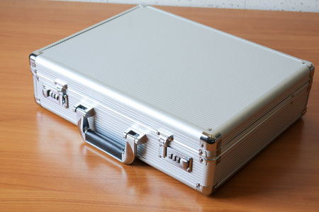 A sleek business attache case resting a wooden surface perfect for professional use.の写真素材