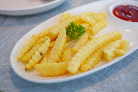 Golden crinkle-cut fries served with ketchup showcasing a delicious snack experience.