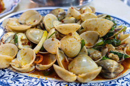 Savor a flavorful clam dish served in a vibrant local restaurant showcasing a culinary delight.の写真素材