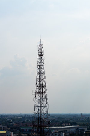 A telecommunications tower stands tall against a cloudy sky symbolizing urban connectivity and modern technology.の写真素材