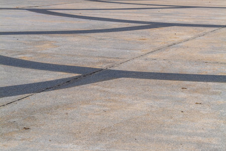 Explore the artistic interplay of shadows and curves urban pavement.の写真素材