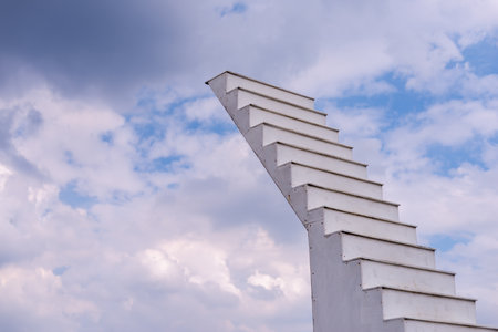 A striking staircase design ascends towards the clouds symbolizing aspiration and creativity.