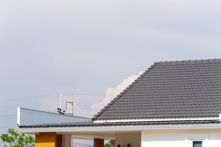 A glimpse of a modern home design set against a cloudy sky in a suburban area.の写真素材