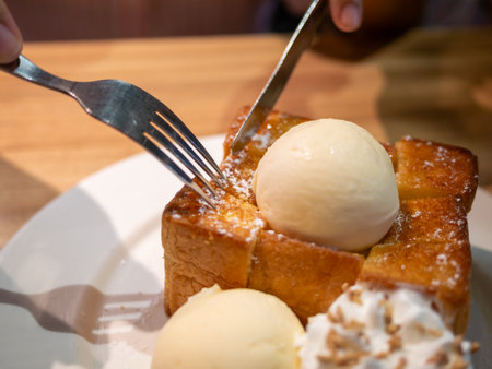 Experience a cozy dessert moment with warm toast topped with ice cream capturing sweet indulgence in every bite.の写真素材
