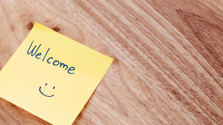 A cheerful sticky note brings warmth to a home office creating a welcoming atmosphere for work.の写真素材