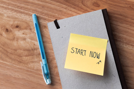 A motivational note urging action placed a wooden desk inspiring creativity and productivity.