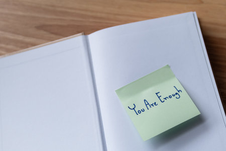 A close-up of a sticky note with an uplifting message promoting self-affirmation and positivity.の写真素材