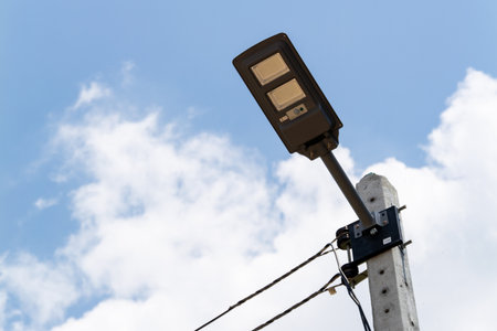 A close-up view of a modern street light mounted a pole in an urban area showcasing innovation in city lighting.の写真素材