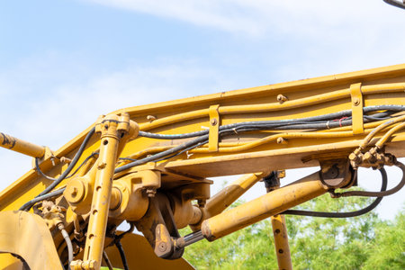 A close-up of heavy machinery at a construction site showcasing intricate hydraulic systems.の写真素材