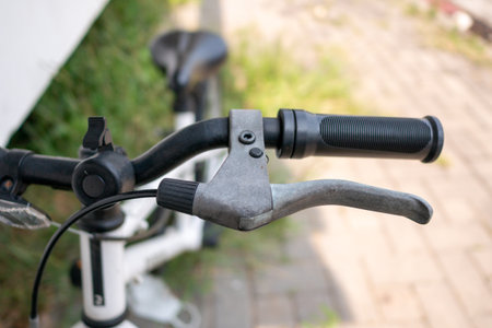 Explore the excitement of biking in an urban park with a close-up view of bicycle handlebars.