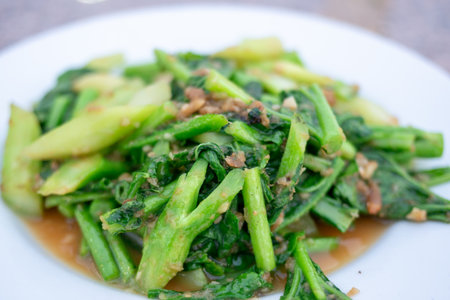 A vibrant plate of stir-fried greens showcasing healthful ingredients and cooking techniques.