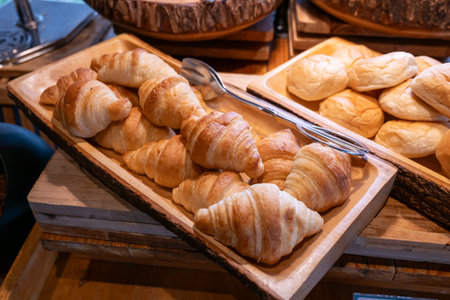 Indulge in the warm flaky perfection of freshly baked croissants at a cozy bakery.