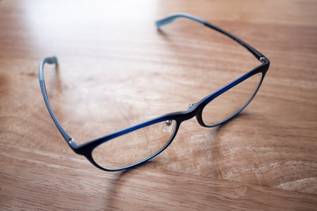 Discover the elegance of stylish eyeglasses in this minimalist wooden setting.