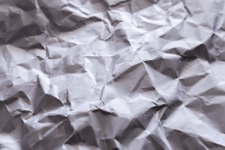 Explore the intricate details of crumpled paper texture in a minimalist studio setting.の写真素材