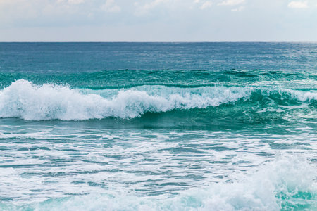 Experience the beauty of crashing waves a tranquil beach showcasing nature's serene ocean landscape.の写真素材