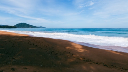 A tranquil scene of waves gently breaking a secluded beach perfect for relaxation and nature appreciation.の写真素材